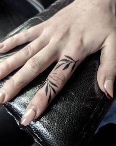 a woman's hand with a tattoo on it