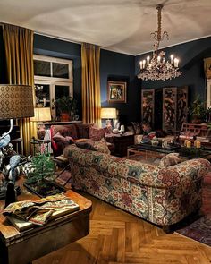 a living room filled with furniture and a chandelier