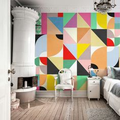 a bedroom decorated with colorful geometric wallpaper