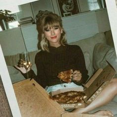 a woman sitting on a couch holding two pizzas in front of her and one slice missing