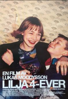 two young boys are hugging each other in front of a poster for the film julia and ever