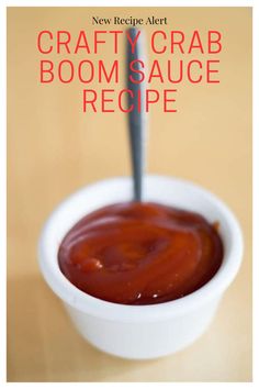 a white bowl filled with ketchup on top of a wooden table