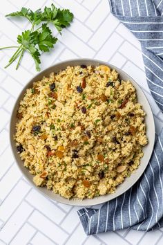 a bowl filled with rice and vegetables on top of a table