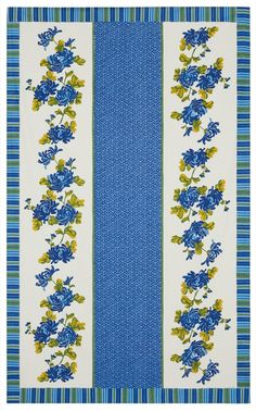 a blue and white table cloth with flowers on the border, in front of a striped background