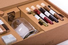 an open box containing several different types of condiments, including pepper grinder and salt shaker