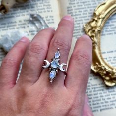 moon ring, witchy jewelry, moonstone ring, crescent moon, moon witch, lunar love, crystal jewelry, fantasy jewelry, silver ring, ooak ring Three moonstones sit in a line and are flanked by two crescent moons. The moons have been textured to add that extra contrast to the shiny stones.  The ring is a size 7 US.  All components of the ring and hand fabricated in sterling silver and plated with 18k white gold.  The back settings of the stones are open to allow natural light to pass through.  Please message me if you have any questions! Silver Moonstone Ring With Moon Phase, Mystical Moonstone Ring, Silver Moon Shaped Bohemian Crystal Ring, Silver Moon-shaped Bohemian Crystal Ring, Mystical Sterling Silver Moonstone Ring With Moon Phase, Celestial Style Silver Moonstone Ring, Silver Bohemian Moon Shaped Crystal Ring, Silver Bohemian Moon-shaped Crystal Ring, Spiritual Sterling Silver Moonstone Ring With Moon Phase