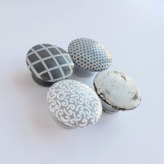 four decorative rocks sitting on top of a white table