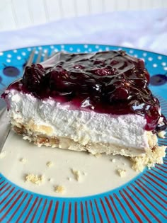 a piece of cheesecake on a blue and white plate with a fork in it