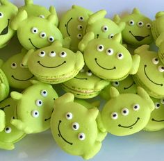 there are many green cookies with faces on them