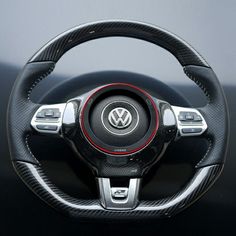 the steering wheel cover is black with red stitchs and has a white stripe on it