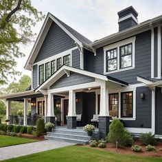 a gray house with white trim and windows