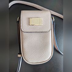 Alessi Chit Chat Crossbody By Guess Pristine. Never Used 4"W X 7"H X 1-3/7"D (Width Is Measured Across Thebottom Of Handbag); 0.48 Lbs. Approx. Weight Silhouette Is Based Off 5'9" Model 22-3/4"L Adjustable Crossbody Strap Magnetic Snap Closure Pale Shiny Gold-Tone Exterior Hardware & Logo Plaque 1 Interior Slip Pocket Base: Polyurethane; Trim: Polyurethane Chic Beige Phone Bag With Cell Phone Pocket, Elegant Beige Phone Bag With Cell Phone Pocket, Beige Crossbody Phone Bag With Card Slots, Beige Crossbody Phone Bag With Detachable Strap, Crossbody Guess, Blush Crossbody Bag With Gold-tone Hardware, Guess Shoulder Bag Sofybrands, Chit Chat, Guess Bags