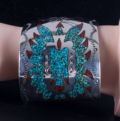 Vintage 1970's Sterling Silver Navajo Inlay Turquoise Coral Bird Cuff BraceletMetal Information: Sterling SilverTotal Weight: 85.3gBracelet Width: 2"Bracelet Length: 6" (Opening: 1.5")Circa: 1970'sArtist: B. EENStone InformationMain StoneGem Type: TurquoiseShape: InlayColor: Blue / GreenAccent StonesGem Type: CoralShape: InlayColor: RedEstimated Retail Price: $1400.00OUR PRICE: $1120.0044651 Southwestern Style Turquoise Inlay Bracelets, Southwestern Style Turquoise Cuff Bracelet With Inlay, Southwestern Turquoise Bangle, Southwestern Turquoise Inlay Bracelet, Southwestern Turquoise Cuff Bracelet With Inlay, Vintage Turquoise Bracelet With Inlay, Vintage Turquoise Cuff Bracelet With Concho, Bohemian Turquoise Inlay Cuff Bracelet, Sterling Silver Turquoise Cuff Bracelet With Inlay