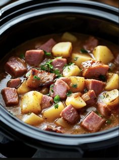 a slow cooker filled with ham and potatoes