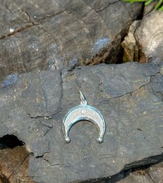 This exquisite Enamel Lunar Amulet, known as Lunnitsa or Lunula, is a symbol of ancient protection and feminine power. Crafted from high-quality silver and featuring delicate enamel detailing, this moon-shaped talisman is believed to bring good fortune, fertility, and protection to its wearer. Historically worn by women in Slavic and Baltic cultures, the Lunula pendant is a timeless piece of lunar-inspired jewelry, perfect for those seeking a deeper connection with the moon's mystic energy. Ideal for lovers of ancient symbolism, mythology, or unique handcrafted jewelry. Good Luck Moon Charm Pendant Jewelry, Silver Amulet Jewelry With Moon Charm, Silver Crescent Bohemian Jewelry, Bohemian Silver Crescent Jewelry, Nickel-free Half Moon Bohemian Jewelry, Bohemian Half Moon Nickel-free Jewelry, Bohemian Engraved Jewelry For Good Luck, Adjustable Moon Charm Amulet Jewelry, Artisan Jewelry With Moon Charm As Gift