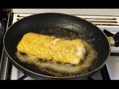 an omelet is being cooked in a frying pan on top of the stove