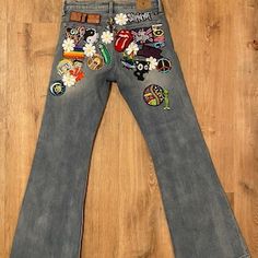 Hippie Style Fitted Jeans, Fitted Hippie Jeans, Trendy Wide-leg Flare Jeans For Festivals, Trendy Wide Leg Flare Jeans For Festival, Hippie Fitted Wide Leg Flare Jeans, Trendy Fitted Jeans With Patches, Trendy Fitted Bottoms With Patches, Hippie Fitted Denim Jeans, Retro Wide Leg Patchwork Jeans