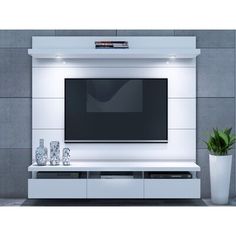 a white entertainment center with a flat screen tv mounted on it's side wall