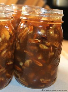 two jars filled with food sitting on top of a table