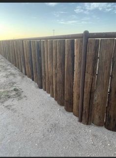 a wooden fence is shown in the sand