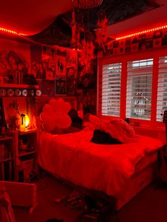 a bedroom with red lights and decorations on the walls, bed in front of window