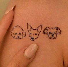 three small dogs on the side of a woman's stomach, with their faces drawn in black ink