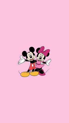 two mickey and minnie mouses hugging each other on a pink background with the word disney written