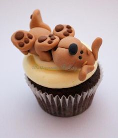 there is a cupcake that has been made to look like a dog on top