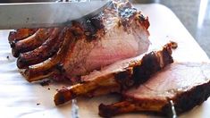 the meat is being sliced on the cutting board