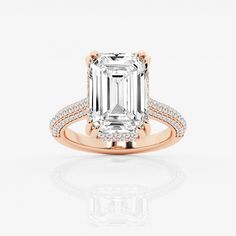 an emerald - cut diamond engagement ring set in 18k rose gold