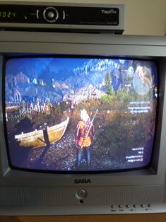 an old tv sitting on top of a wooden table