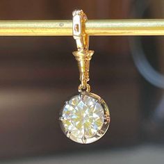 This Georgian Victorian Ball Chain Pendant is set with a 2 carat lab diamond in a Georgian cut-down collet setting and is designed to hang from any of the ball chain necklaces. This pendant is a tribute to the intricate designs of the past, showcasing a delicate pendant that exudes timeless charm. The pendant is handcrafted in 18k blackened gold and 18k yellow gold, which is designed with versatility in mind. Item Details • Made to Order.• Gold Kt: 14K or 18K Solid Gold• Custom Gold Color: Rose Classic Briolette Jewelry In Diamond White, Classic Diamond White Briolette Jewelry, Classic Briolette Diamond White Jewelry, Luxury Single Diamond Round Cut Jewelry, Luxury Jewelry With Single Round Cut Diamond, Diamond Dangle Jewelry With Prong Setting, Classic Briolette Cubic Zirconia Jewelry, Rose Gold Briolette Diamond Jewelry, Classic Dangle Diamond Cut Jewelry