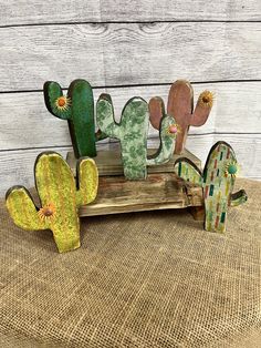 three wooden cactus sculptures sitting on top of a table