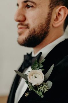 a man in a tuxedo with a boutonniere on his lapel