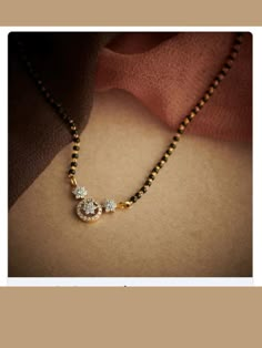 mangalsutra designs Neck Nallapusalu Designs, Black Beads With Earrings Set, Mangalsutra With Diamond Pendant, Small Manglsutr Design, Small Black Beads Chain Gold, Diamond Nallapusalu Designs, Magalsutram Chain Designs Gold, Black Mangalsutra Designs, Latest Mangalsutra Designs 2023