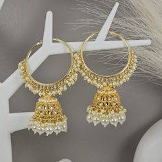 Indulge in timeless elegance with our Antique Gold Polki Hoop Earrings. Crafted to perfection, these earrings exude vintage charm with their antique gold finish and intricate polki stone detailing. Elevate your style and make a statement with these exquisite hoop earrings, perfect for any occasion. Shop now and add a touch of sophistication to your jewelry collection! White Hoop Earrings For Festive Wedding, White Round Chandbalis For Celebrations, White Hoop Earrings For Wedding And Festive Occasions, Festive White Hoop Earrings For Wedding, Silver Cutdana Chandelier Earrings For Wedding, Elegant Cutdana Hoop Earrings For Diwali, Elegant Hoop Jewelry With Latkans, Elegant Hoop Earrings With Tassels, Wedding Silver Cutdana Chandelier Earrings