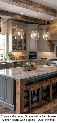 a large kitchen with an island in the middle and two pendant lights hanging from the ceiling