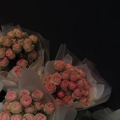 there are many roses in the bouquets on the table and one has pink flowers