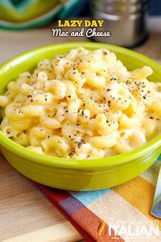 a green bowl filled with macaroni and cheese