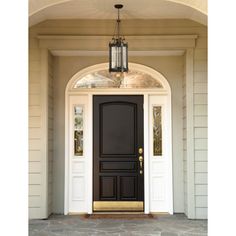 a black front door with a potted plant on the side