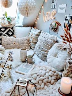 a living room filled with lots of pillows and blankets