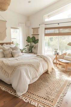 a large bed sitting in a bedroom on top of a wooden floor next to a window