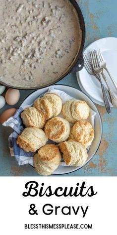 biscuits and gravy on a plate next to an egg in a skillet