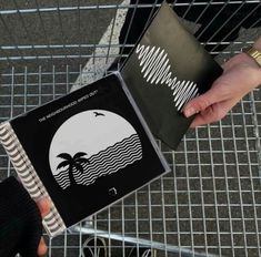 a person holding a box with an image of a palm tree on it