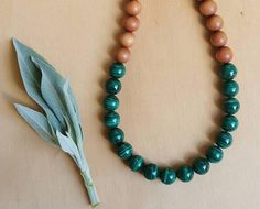 "A stunning set of ethnic style wooden beads.  This necklace is made up of beautiful, vibrant green  Malachite and Aromatic Sandalwood beads. Healing properties of Malachite 💚 Malachite is a beautiful heart chakra crystal, benefiting both the emotional and physcical heart.  It assists one in finding the joy in life.  It also benifits the solar plexus, promoting alignment and expression of both personal and divine will. Its energy reminds us that we are co creators in this world and that the pos Traditional Green Necklace For Meditation, Earthy Green Necklace With Wooden Beads, Nature-inspired Green Jewelry With Wooden Beads, Green Polished Beads Mala As Gift, Green Polished Beads Mala For Gift, Gift Green Polished Beads Mala, Green Mala With Polished Beads As Gift, Traditional Green Necklace For Healing, Green Spiritual Necklace With Wooden Beads