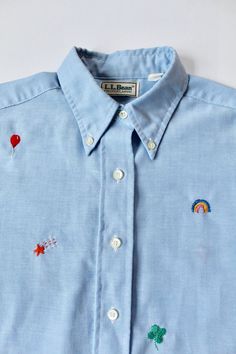 "Adorable hand-embroidered button-down from the Picky Stitches collection. Can you spot the theme? Each individual stitching pays homage to a favorite childhood cereal! Personally, we like the moon the best :) This piece has been upcycled with care and is in excellent condition. The original shirt is made by L.L. Bean. Labeled size L. Please see measurements for accurate fit: Length: 25\" Shoulders: 15.5\" Chest: 39\" Sleeve length: 24\" If you have any questions, please don't hesitate to send u Multicolor Embroidered Button-up Top, Cotton Tops With Multicolor Embroidery And Button Closure, Rose Skirt, Upcycled Clothing, Clothing Vintage, Vintage Velvet, Cute Skirts, Shirt Long Sleeve, Vintage Shirt