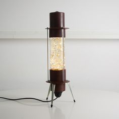 Original vintage motion lamp, circa 1970s-1980s, USSR. This beautiful and mesmerizing lamp will be a fantastic addition to your living room. It can be used as a nightlight or for parties. The lamp is in perfect condition, with new wiring and plug installed, along with the original bakelite bulb holder. This lamp features sparkling elements that create a beautiful effect, floating up and down as the lamp heats up. Dimensions: Height: 50 cm (19.7 inches) Lamp diameter: 12 cm (4.7 inches) Foot diameter: 16 cm (6.3 inches) Cord length: 190 cm (74.8 inches) * Voltage: 220V * Wire conducts electricity whether it is 110 volt or 220 volt - wire doesn't discriminate. So long as you use a bulb purchased in the US (made for 110-volt usage), you don't have to worry about the voltage difference. All ou Vintage Lighting Ideas, Mid Century Modern Lamps, Lampe Vintage, Retro Rocket, Lava Lamps, Lamp Retro, Modern Lamps, Industrial Chandelier, Table Lights