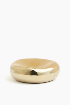 a gold ring sitting on top of a white surface