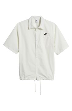 An adjustable drawstring hem changes up the look of this roomy cotton button-up shirt. 28" length; 48" chest (size Medium) Front button closure Point collar Short sleeves Chest patch pocket Drawstring hem 100% cotton Machine wash, tumble dry Imported Spring Button-up Camp Shirt For Streetwear, White Relaxed Fit Top With Drawstring, Nike Cotton Collared Tops, Nike Casual Collared Shirt, White Camp Shirt For Spring Streetwear, Casual Nike Collared Shirt, Spring Streetwear Button-up Camp Shirt, Cotton Camp Shirt Button-up, Cotton Button-up Camp Shirt For Daywear