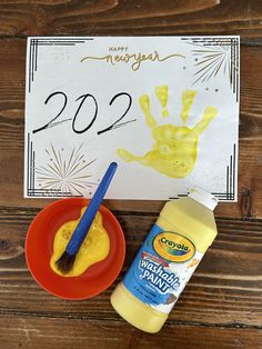 a table with paint and a sign that says happy new year